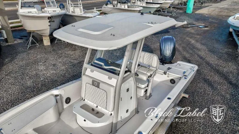 Slide: The Image of 2024 Sea Fox Seafox 251 Bay boat with T-top and outboard motor at marina. - 4