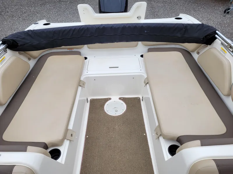 Slide: The Image of 2017 Bayliner Element E21 boat interior with beige seating and black backrest. - 12