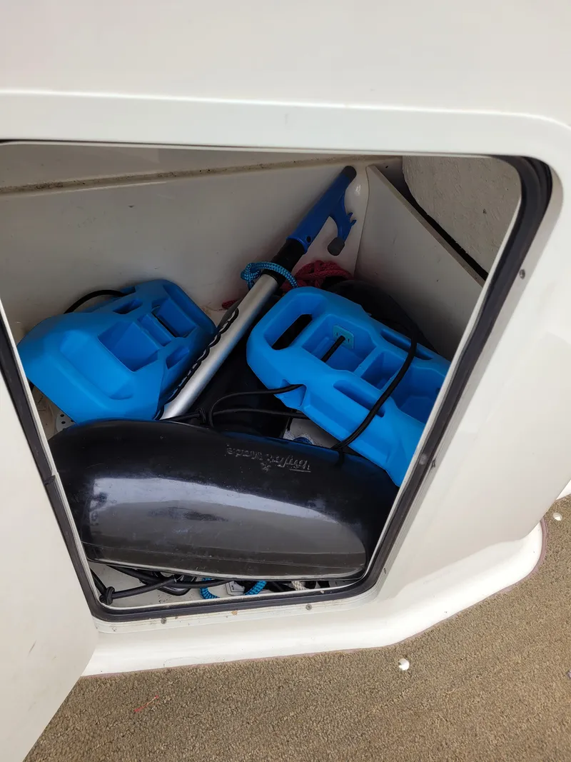 Slide: The Image of Storage compartment of a 2017 Bayliner Element E21 boat with blue accessories. - 14
