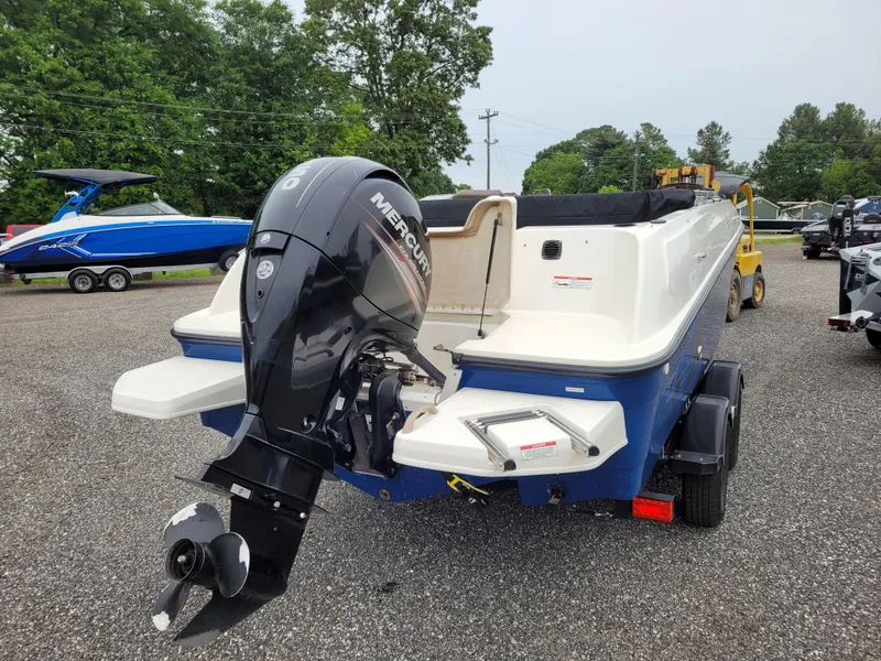 Slide: The Image of 2017 Bayliner Element E21 boat with Mercury outboard motor, parked on a trailer. - 5