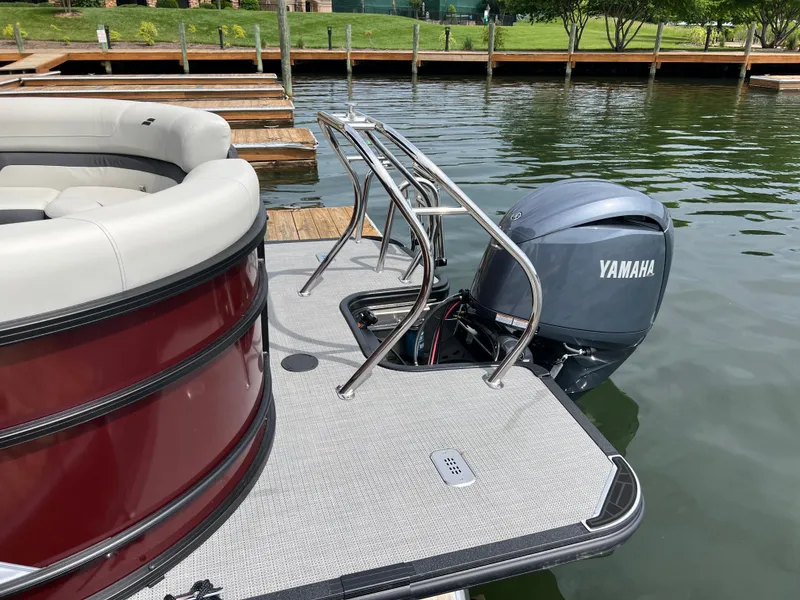 Slide: The Image of 2024 Starcraft EXS 3 pontoon boat with Yamaha outboard motor at dock. - 2