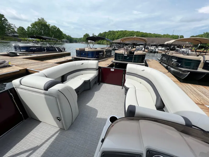 Slide: The Image of 2024 Starcraft EXS 3 pontoon boat interior at a marina. - 3