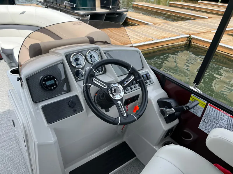 Slide: The Image of 2024 Starcraft EXS 3 boat dashboard with steering wheel and control panel. - 5