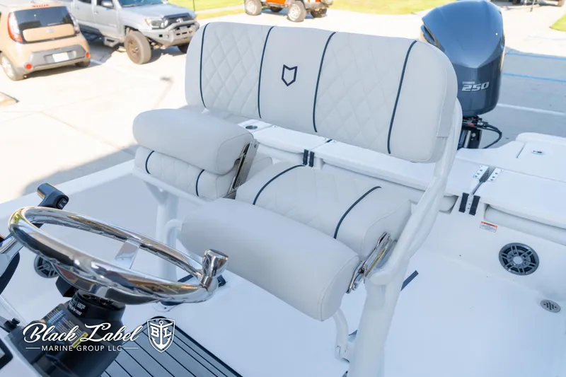 Slide: The Image of 2024 Sea Fox Seafox 251 Bay boat interior with plush seating and steering wheel. - 16