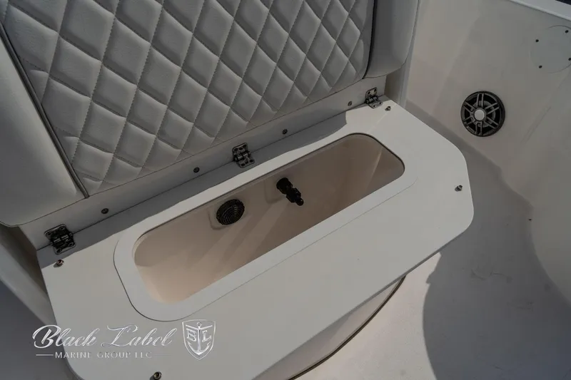 Slide: The Image of 2024 Sea Fox Seafox 251 Bay boat storage compartment with quilted seat back. - 14
