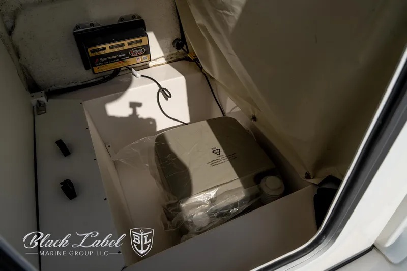 Slide: The Image of 2024 Sea Fox Seafox 251 Bay boat storage compartment with equipment and battery. - 20