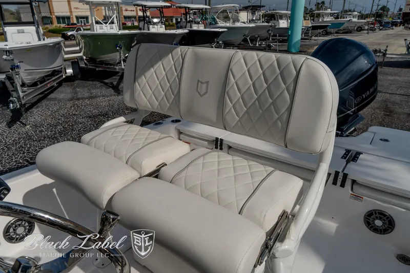 Slide: The Image of 2024 Sea Fox Seafox 251 Bay boat with luxurious quilted seating in a marina setting. - 22