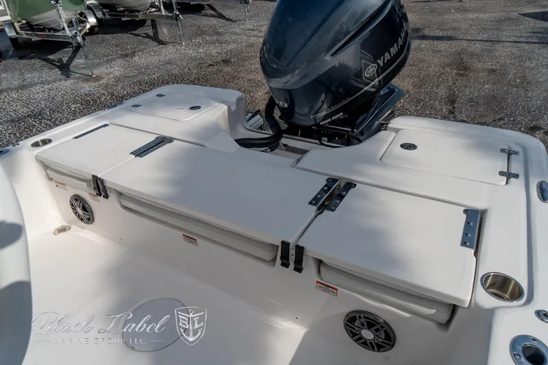 Slide: The Image of 2024 Sea Fox Seafox 251 Bay boat with Yamaha engine, featuring spacious deck and storage compartments. - 23