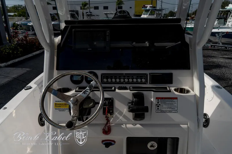 Slide: The Image of 2024 Sea Fox Seafox 251 Bay boat dashboard with steering wheel and controls. - 25