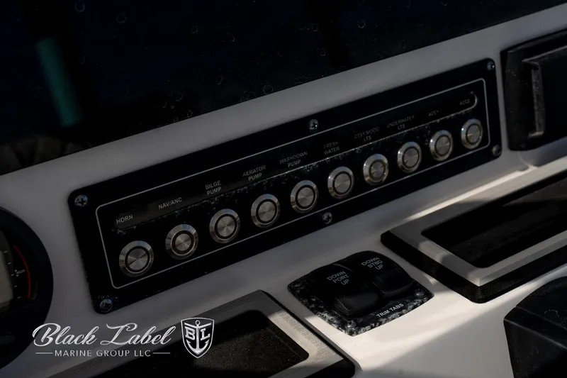 Slide: The Image of 2024 Sea Fox Seafox 251 Bay boat dashboard with control panel and switches. - 28