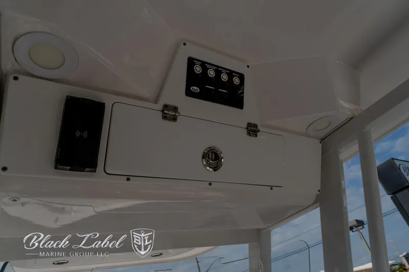 Slide: The Image of 2024 Sea Fox Seafox 251 Bay boat console with control panel and storage compartment. - 31