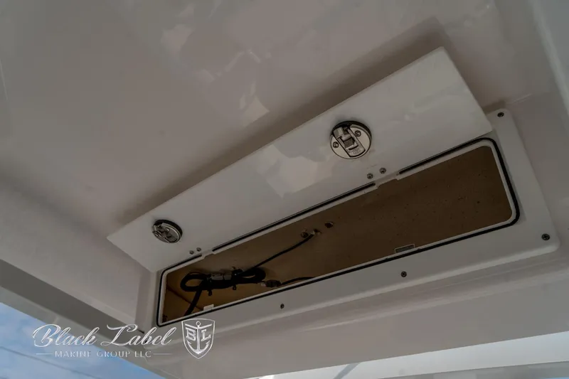 Slide: The Image of 2024 Sea Fox Seafox 251 Bay storage compartment with latch and wiring. - 34
