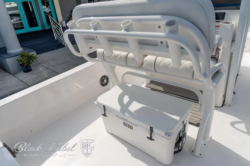 Slide: The Image of 2024 Sea Fox Seafox 251 Bay boat interior with rod holders and cooler. - 35