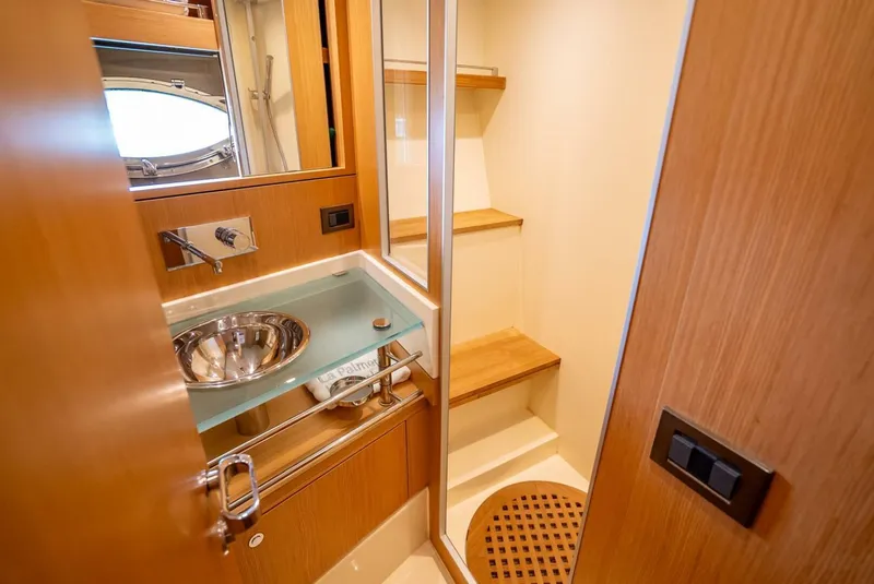 Slide: The Image of Luxurious bathroom on 2012 Riva 56 Sportriva yacht with modern fixtures and wooden accents. - 13