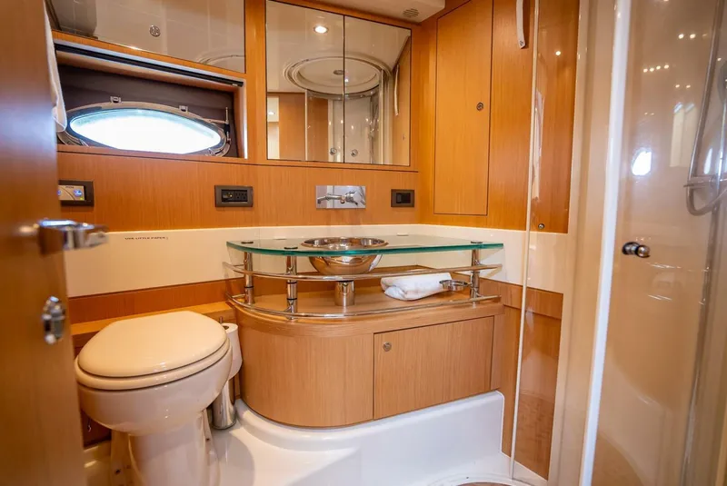 Slide: The Image of Luxurious bathroom in 2012 Riva 56 Sportriva yacht with modern fixtures and wood accents. - 16