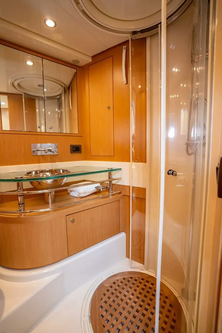 Slide: The Image of Luxurious bathroom in 2012 Riva 56 Sportriva yacht with modern fixtures and wood accents. - 17