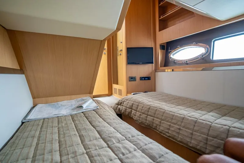 Slide: The Image of Interior cabin of 2012 Riva 56 Sportriva yacht with twin beds and porthole window. - 21