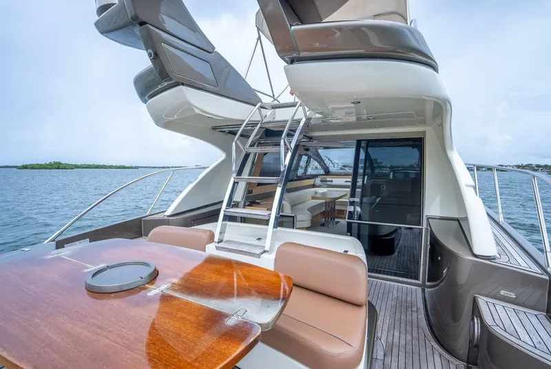 Slide: The Image of 2012 Riva 56 Sportriva luxury yacht with elegant deck and seating area. - 31