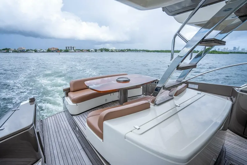 Slide: The Image of Luxurious 2012 Riva 56 Sportriva yacht deck with seating, cruising on open water. - 35