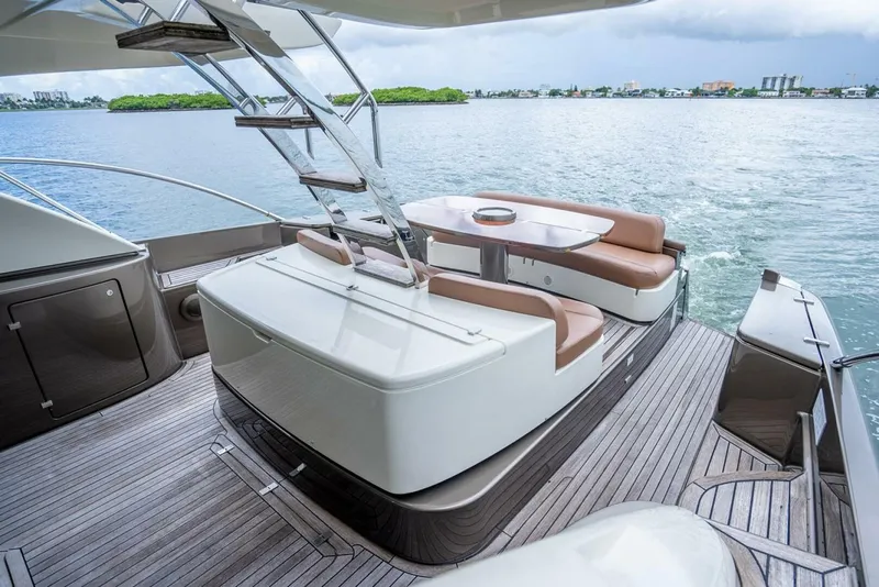 Slide: The Image of Luxurious 2012 Riva 56 Sportriva yacht with elegant deck seating and scenic water view. - 36