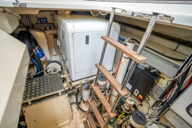 Slide: The Image of Engine room of 2012 Riva 56 Sportriva yacht with equipment and ladder. - 49