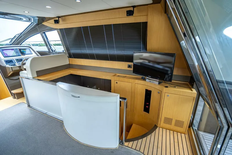 Slide: The Image of Interior of 2012 Riva 56 Sportriva yacht with modern wood paneling and TV. - 9