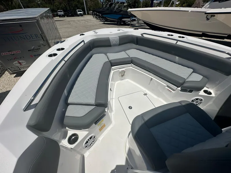 Slide: The Image of 2024 NauticStar 222 OS boat with spacious seating and storage compartments. - 10