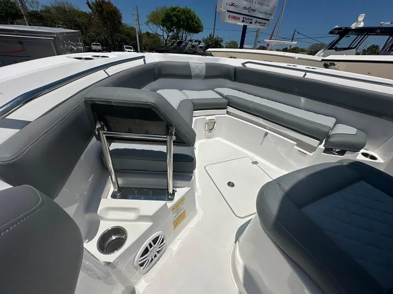 Slide: The Image of 2024 NauticStar 222 OS boat interior with gray seating and stainless steel accents. - 11