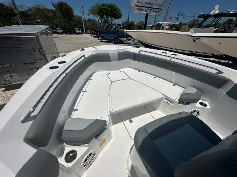 Slide: The Image of 2024 NauticStar 222 OS boat interior with seating and storage compartments. - 12