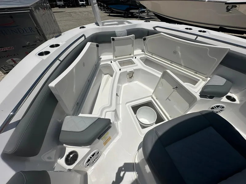 Slide: The Image of 2024 NauticStar 222 OS boat interior with seating and storage compartments. - 13