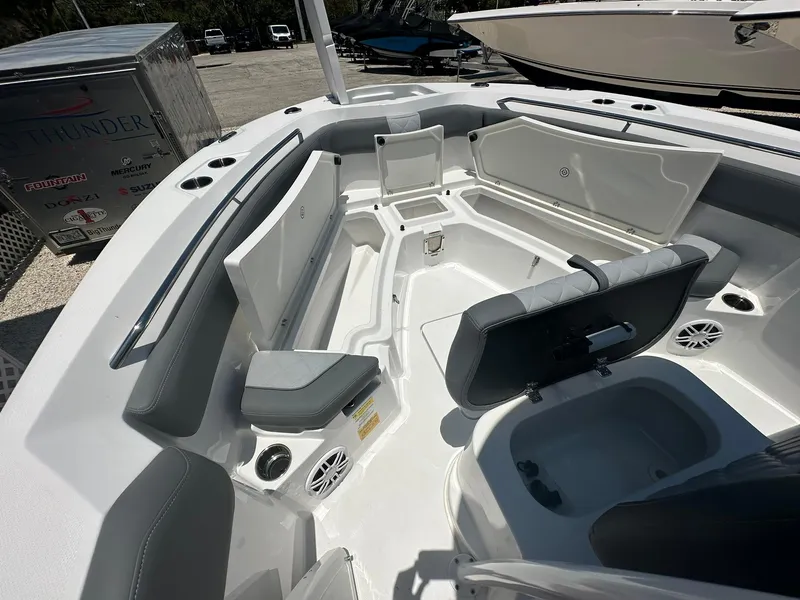 Slide: The Image of 2024 NauticStar 222 OS boat interior with seating and storage compartments. - 14