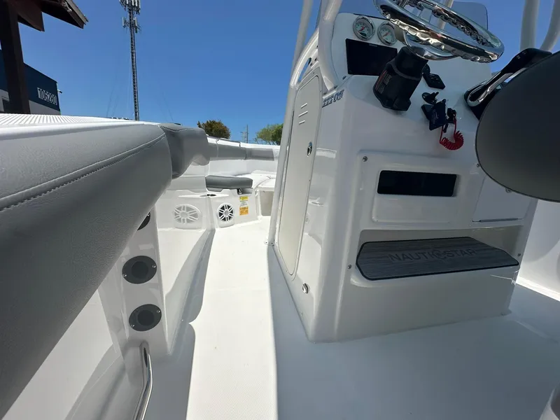 Slide: The Image of 2024 NauticStar 222 OS boat interior with console and seating. - 15