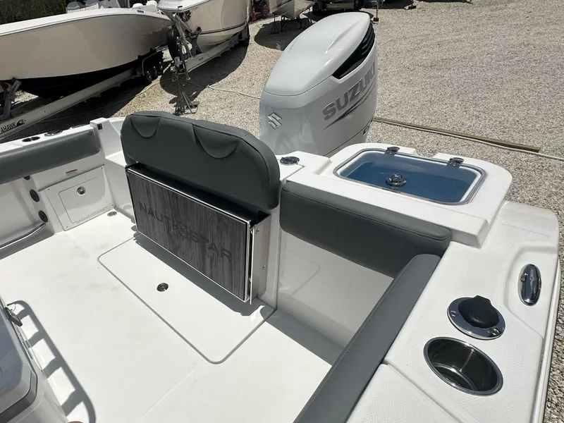Slide: The Image of 2024 NauticStar 222 OS boat interior with Suzuki outboard motor. - 17