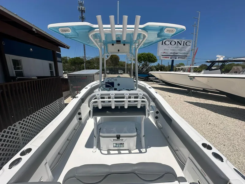 Slide: The Image of 2024 NauticStar 222 OS boat interior with T-top and fishing rod holders. - 19