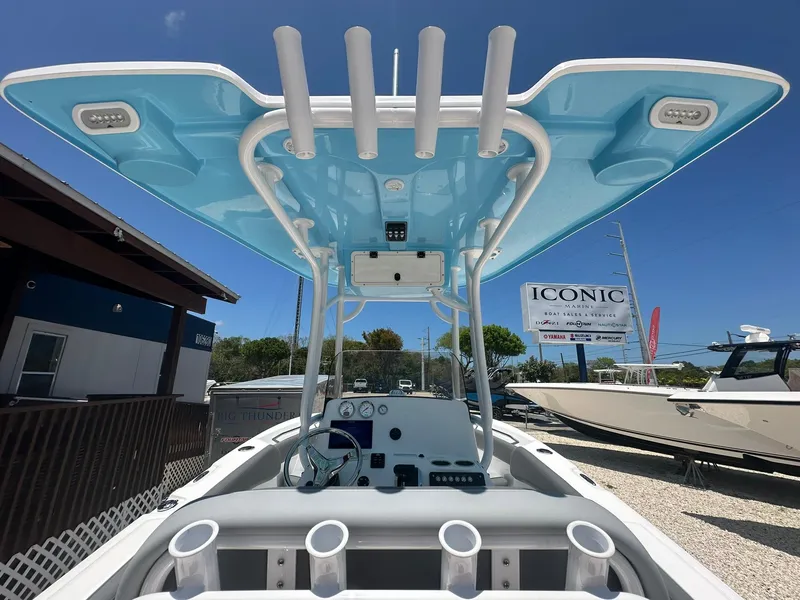 Slide: The Image of 2024 NauticStar 222 OS boat with blue T-top and rod holders. - 20
