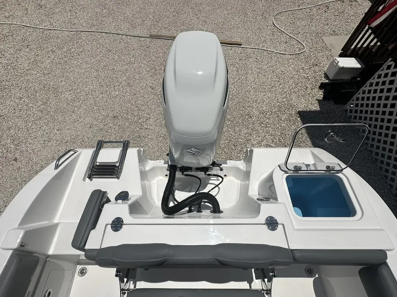 Slide: The Image of 2024 NauticStar 222 OS boat stern with outboard motor and swim platform. - 21