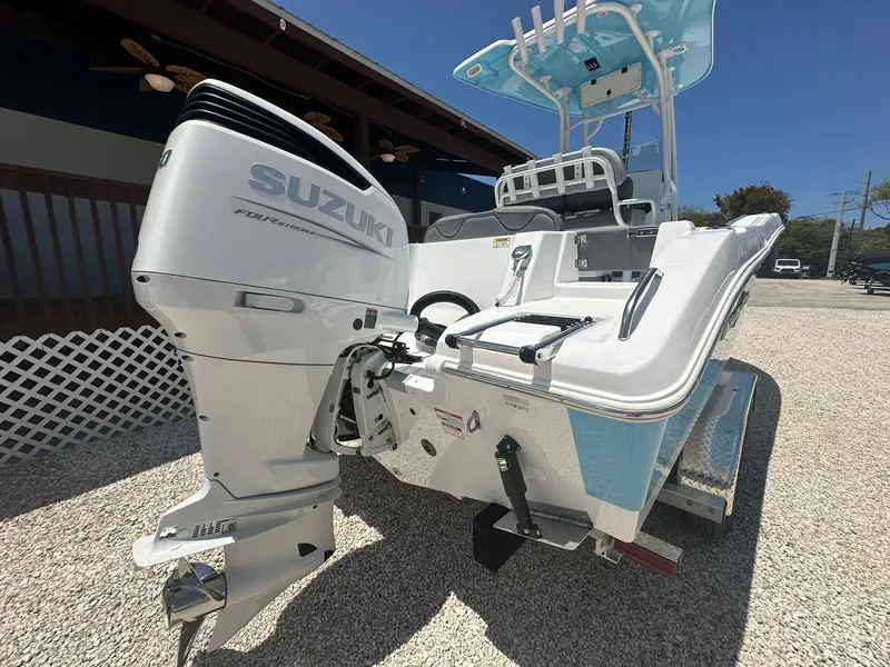 Slide: The Image of 2024 NauticStar 222 OS boat with Suzuki outboard motor, rear view. - 22