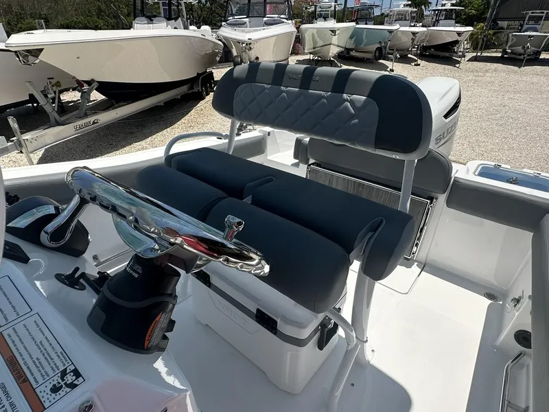 Slide: The Image of 2024 NauticStar 222 OS boat interior with dual seating and steering console. - 3