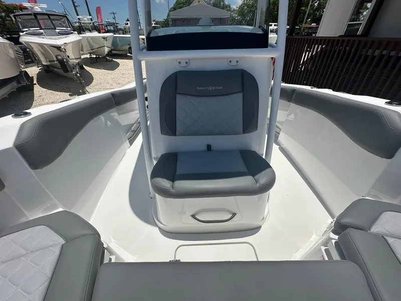 Slide: The Image of 2024 NauticStar 222 OS boat interior with cushioned seating. - 6