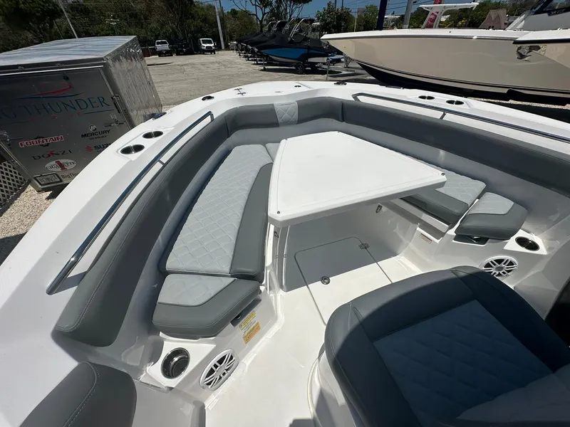 Slide: The Image of 2024 NauticStar 222 OS boat interior with cushioned seating and table. - 9