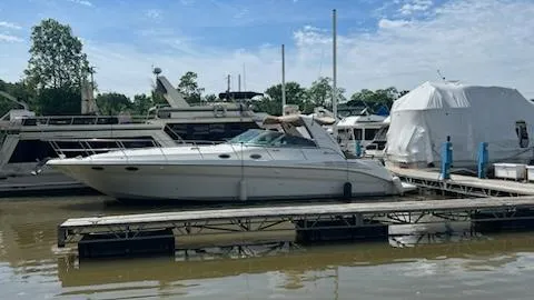 Slide: The Image of 1997 Sea Ray 400 yacht docked at a marina. - 1