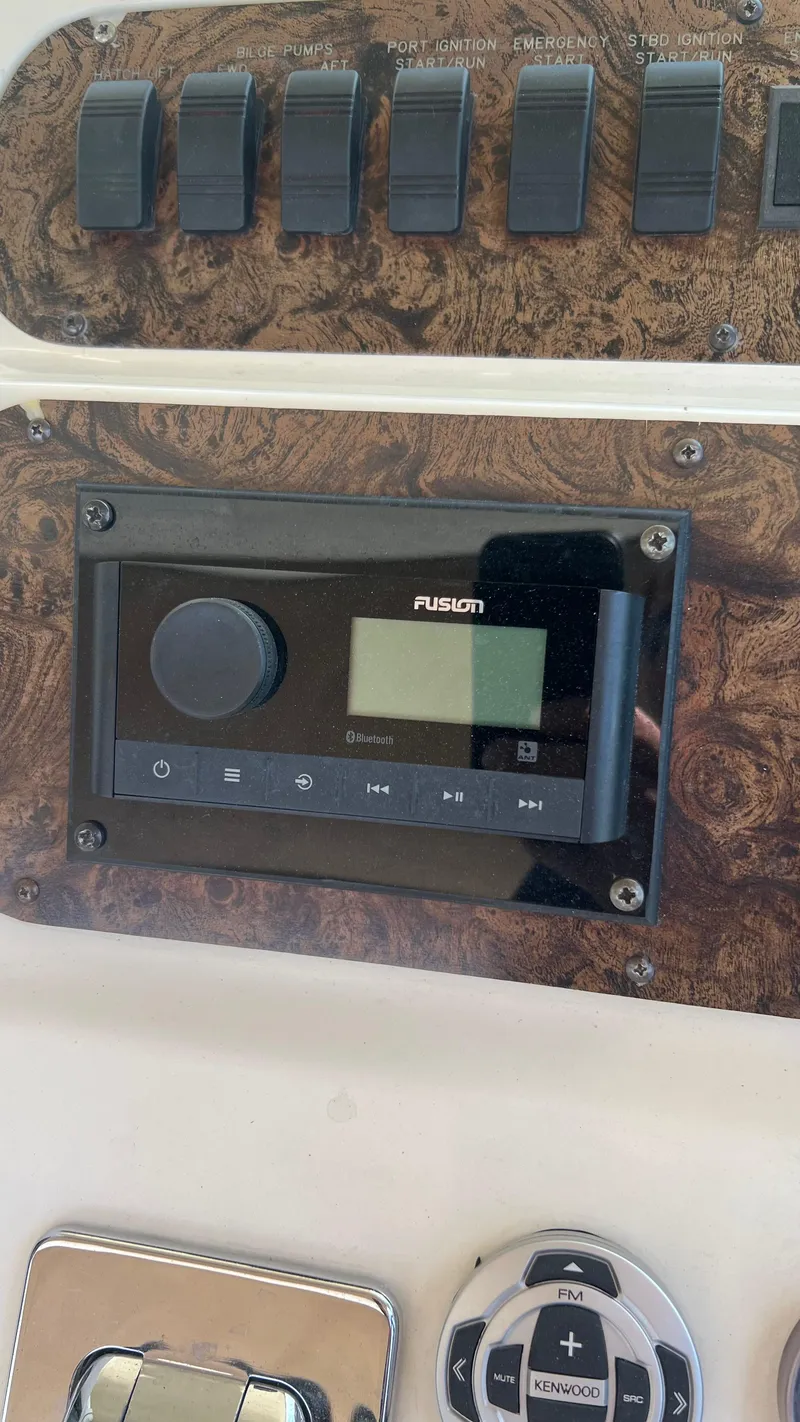 Slide: The Image of Control panel of a 1997 Sea Ray 400 boat with Fusion stereo system. - 16