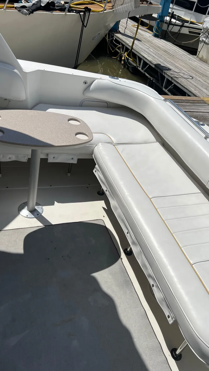 Slide: The Image of Interior seating area of a 1997 Sea Ray 400 boat docked at a marina. - 17