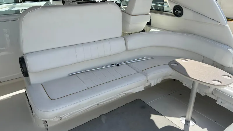 Slide: The Image of 1997 Sea Ray 400 boat interior with white seating and small table. - 18