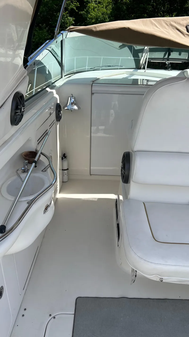 Slide: The Image of Interior of a 1997 Sea Ray 400 boat with seating and a small sink. - 19