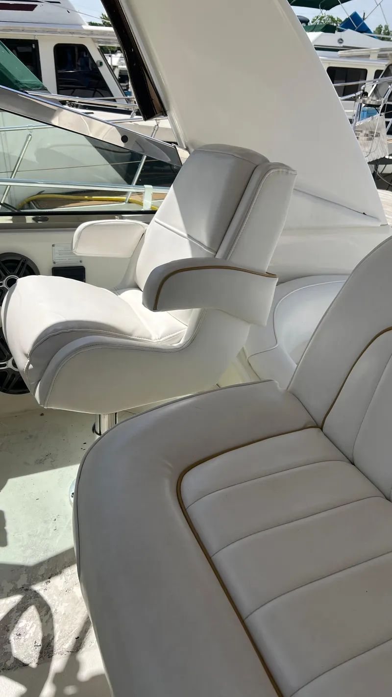 Slide: The Image of Interior seating of a 1997 Sea Ray 400 boat with white leather upholstery. - 21