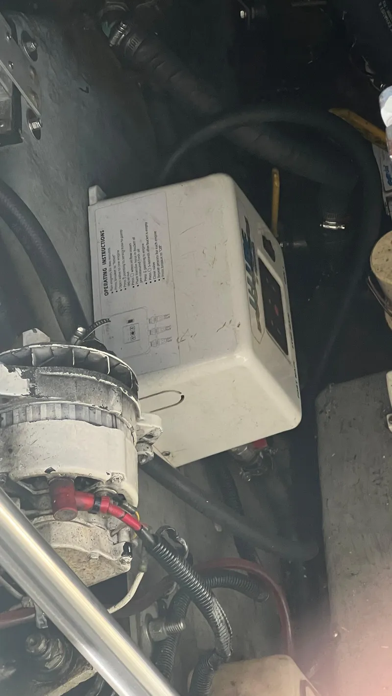 Slide: The Image of Engine compartment of a 1997 Sea Ray 400 boat with visible components and wiring. - 23