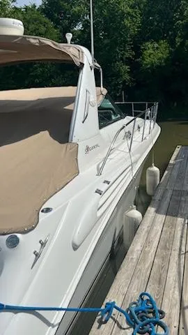 Slide: The Image of 1997 Sea Ray 400 yacht docked at a marina with beige canopy. - 3
