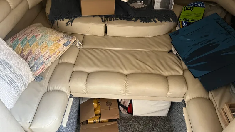 Slide: The Image of Interior seating area of a 1997 Sea Ray 400 boat with cushions and storage. - 31