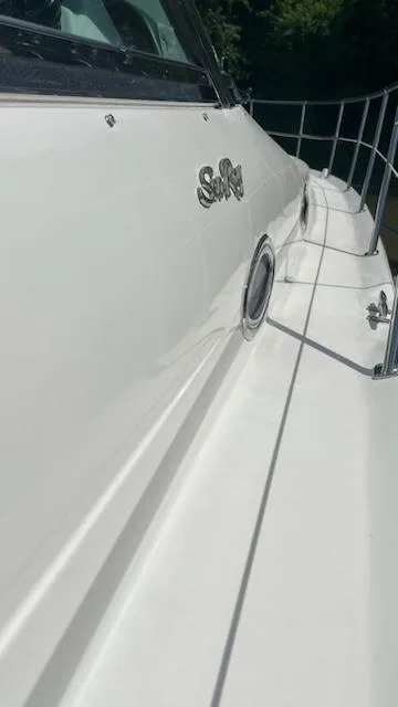 Slide: The Image of Side view of a 1997 Sea Ray 400 boat with railing and logo. - 4